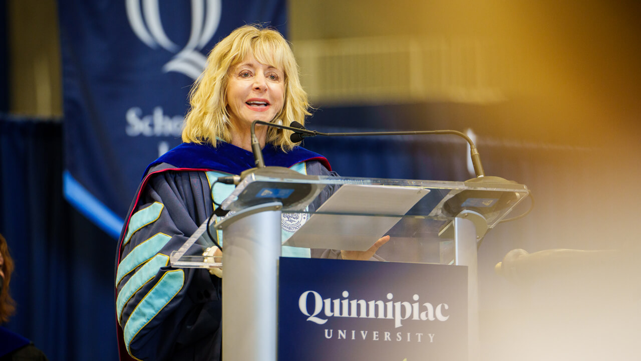 Judy Olian speaks at a podium